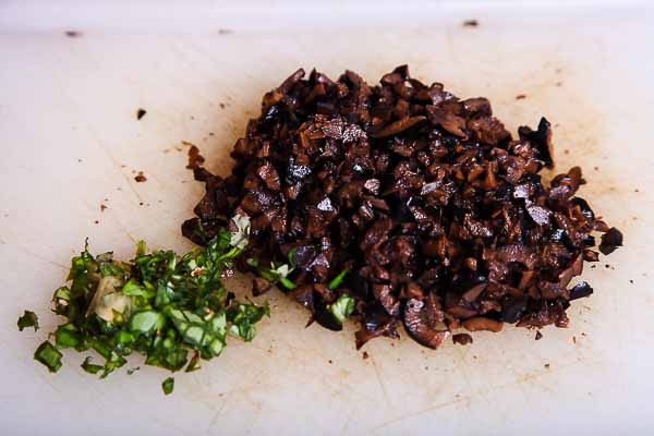 Mince the basil and black olives...