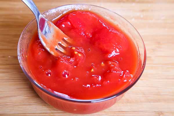 Crush the peeld tomatoes with a fork...